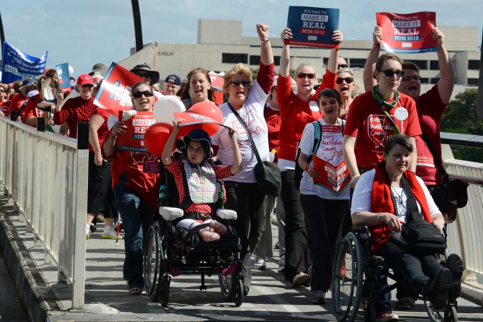 People with disabilities and their supporters march in Brisbane, April, 2012, for a National Disability Insurance Scheme. Credit: Dan Peled, AAP