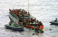 Boat people are rescued by Australian navy personnel. Credit: Publik15, Flickr